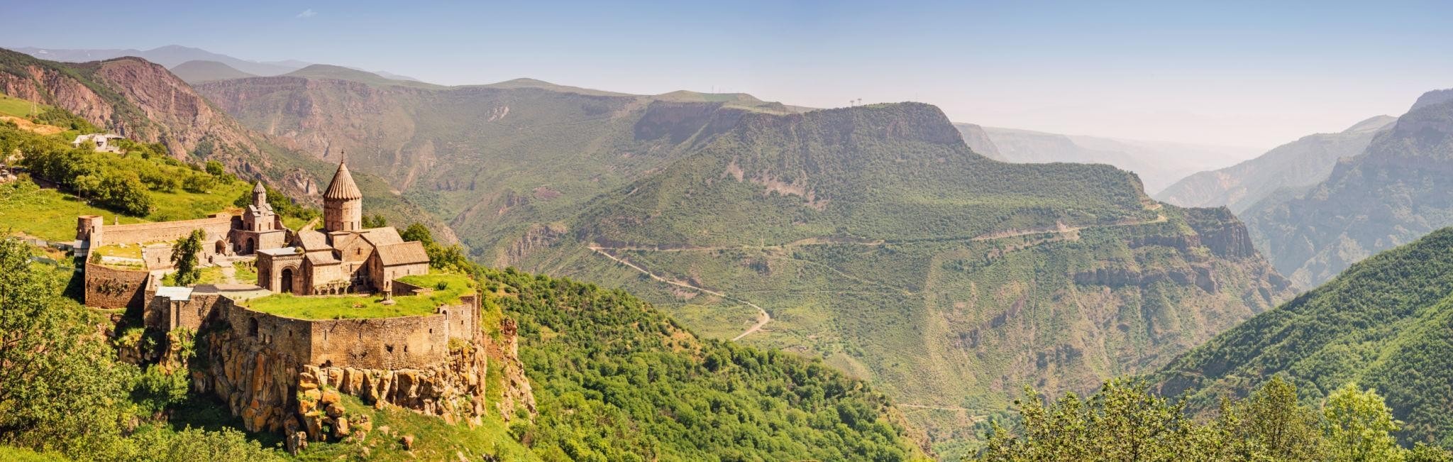 Tatev monastery on its rocky spur above the wide, forested Vorotan gorge