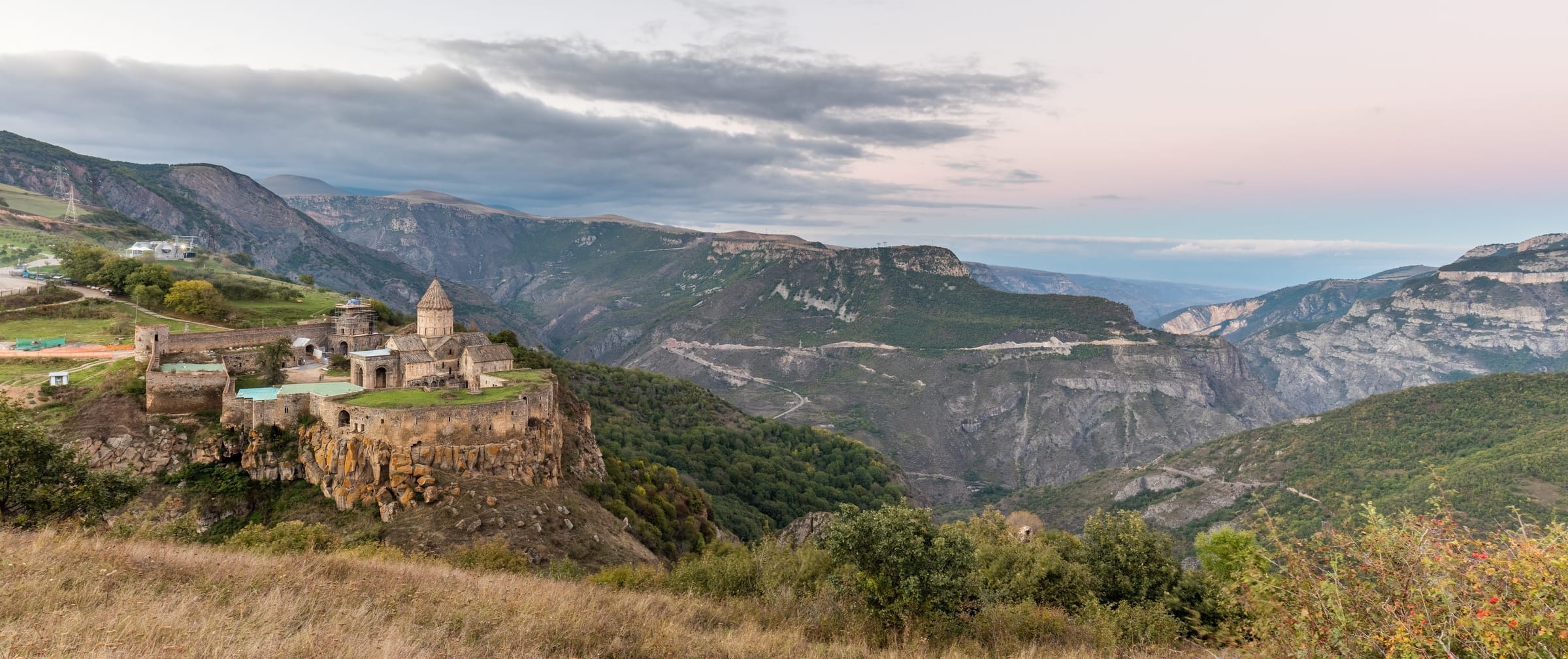 Tatev monastery at dusk high above the deeply carved Vorotan gorge